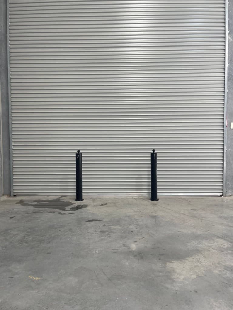 114mm removable bollards installed at a commercial roller door