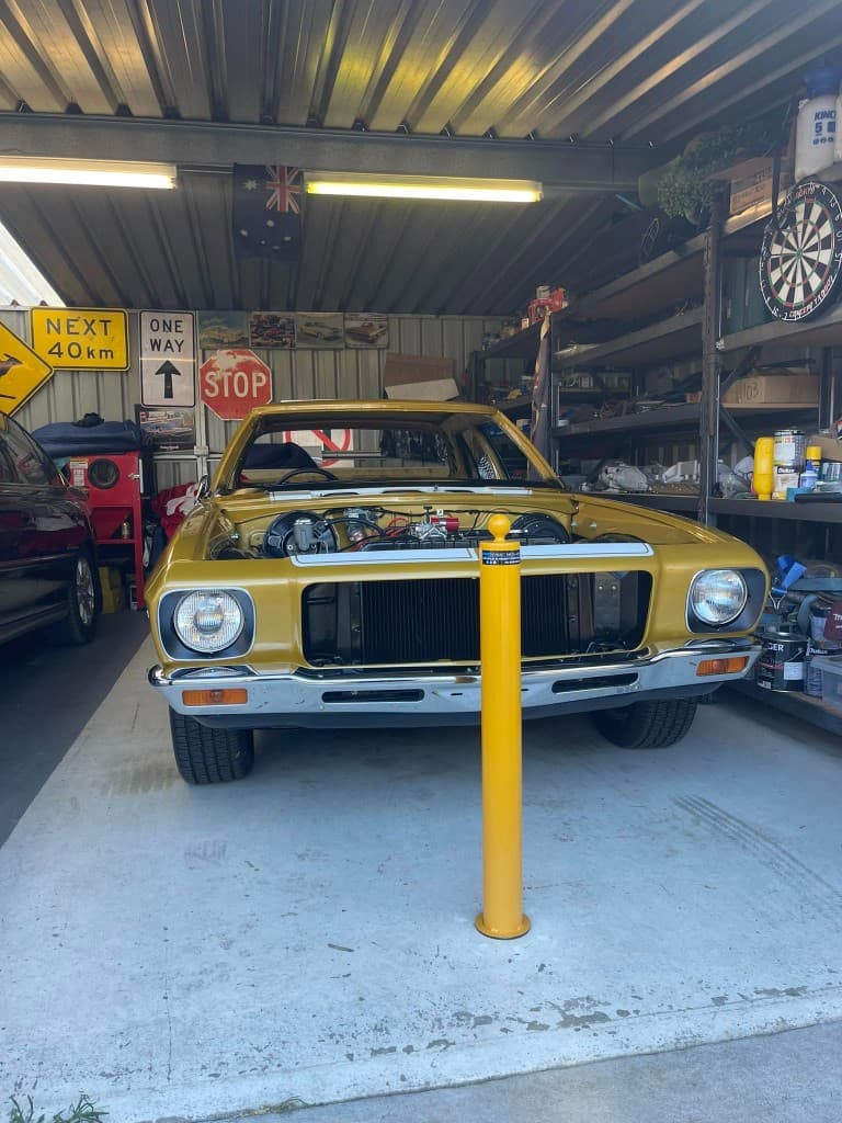 90mm removable bollard protecting a classic car in a workshop