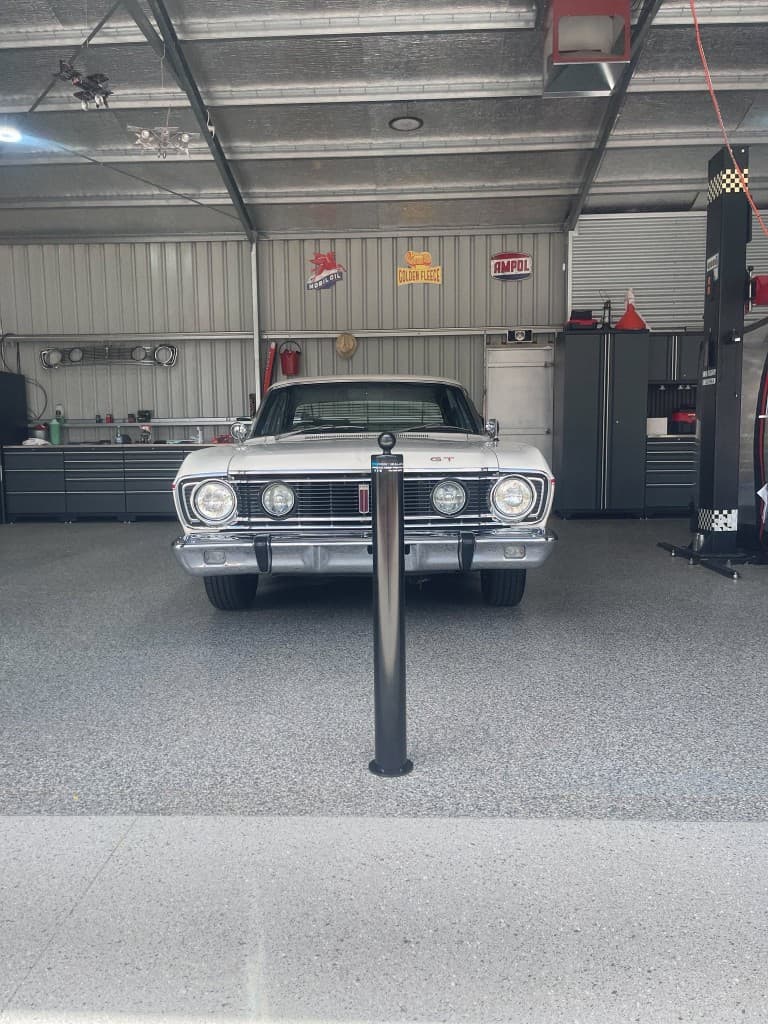 90mm removable bollard protecting a Ford Falcon GT in a workshop garage