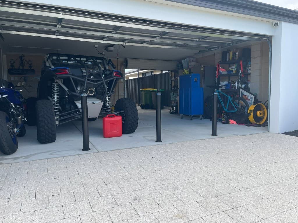 90mm removable bollards installed at a residential garage entrance