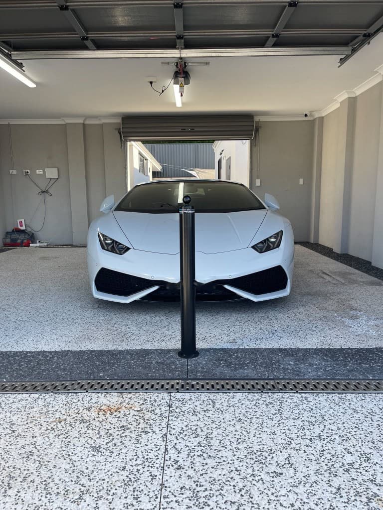 90mm removable bollard protecting a Lamborghini in a residential garage